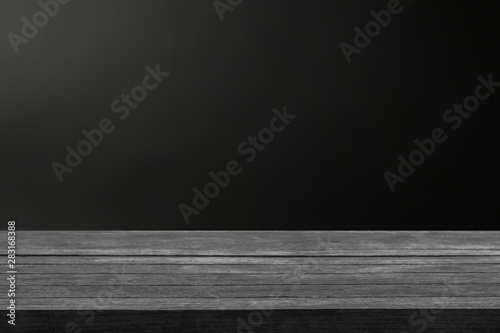 Real dark wood plank desk table top on black background, Can be used for display or montage your products.
