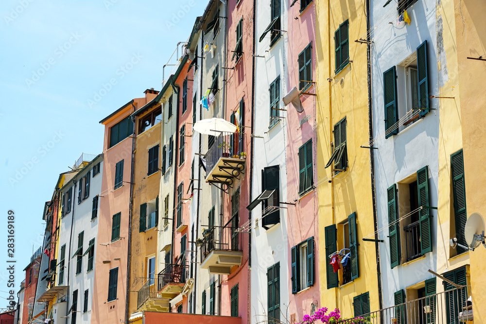 colorful house facades with balconies and typical shutters in the old town of portovenere, liguria, italy