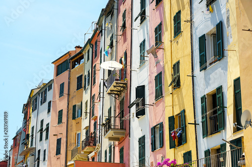 colorful house facades with balconies and typical shutters in the old town of portovenere, liguria, italy