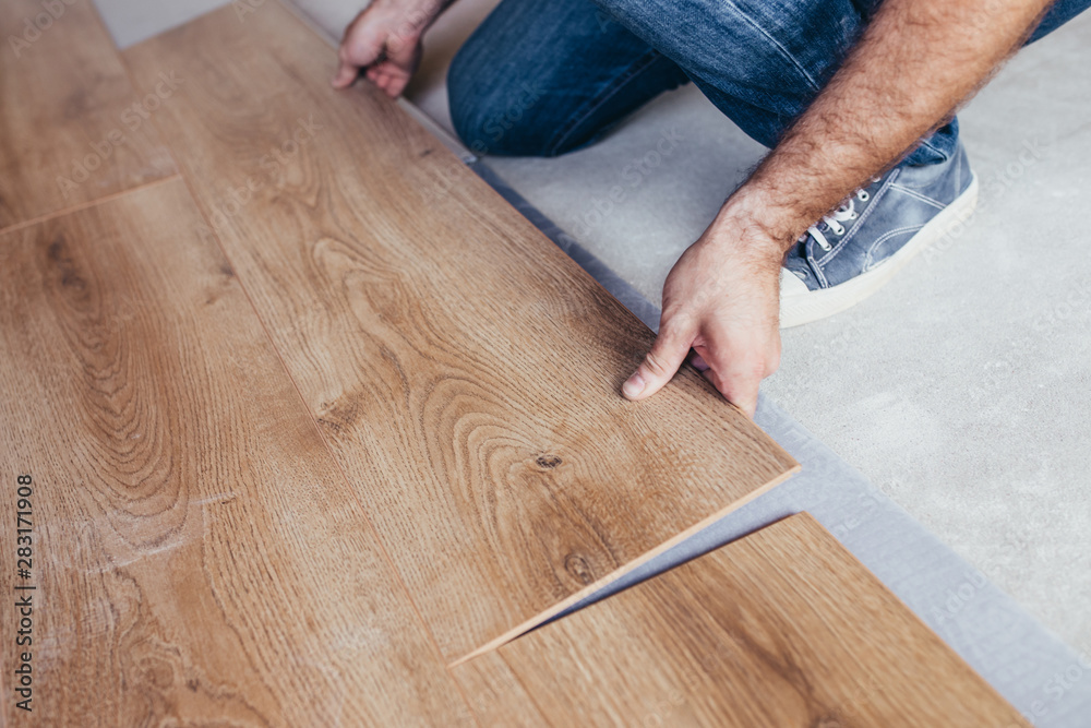 Laying the flooring is a complex and lengthy process that requires considerable effort - before laying the laminate on the floor, you should learn about all the nuances of the work ahead - obrazy, fototapety, plakaty 