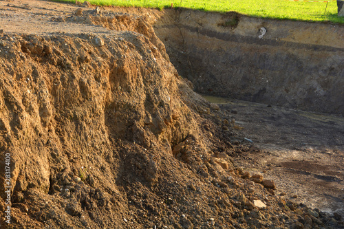 new excavated excavation pit with groundwater at sunrise, excavation with view groundwater