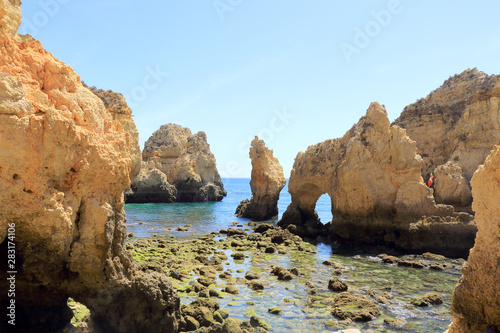 Rocky shoreline at Ponta Da Piedade surrounded by limestone cliffs