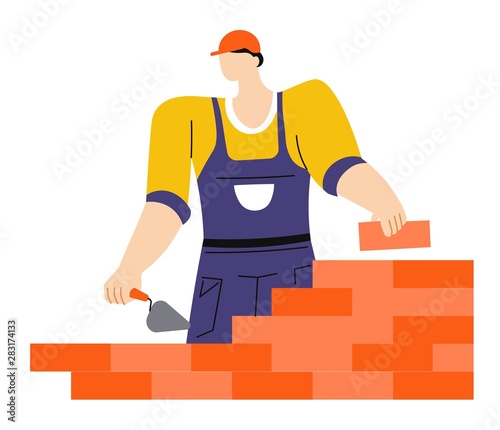 Building or construction works, worker with putty knife and brick wall