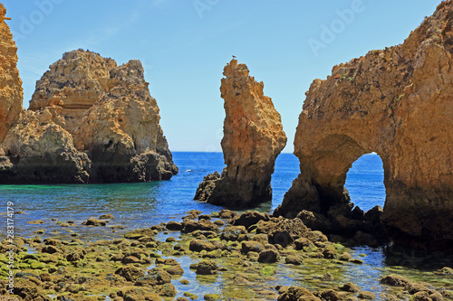 Coastal rock formations and sea arch at the Ponta Da Piedade Headland in Lagos