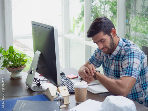 young man working at home and watch,businessman works on his computer to get all his business