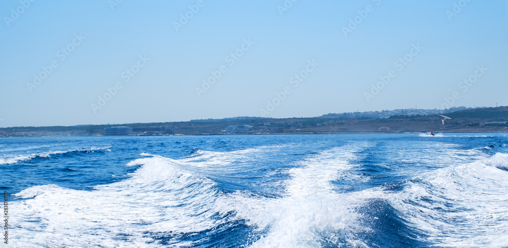 Water wake behind speed boat