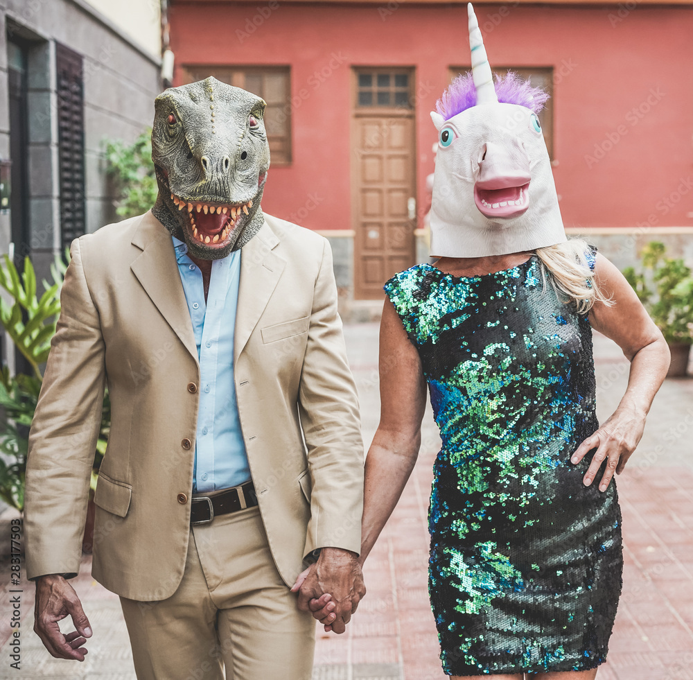 Crazy senior couple walking around city street wearing t-rex and chicken  mask - Old trendy people having fun together- Absurd and funny trend  concept - Focus on faces Stock-foto | Adobe Stock