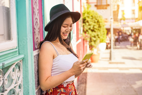 Photography Asian social influencer woman using smartphone outdoor - Happy chinese girl havi