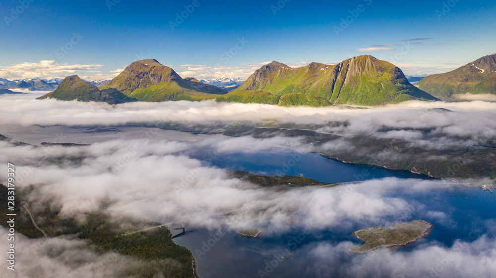 Fish farm at sea. Waterfall. Fjord above the clouds. Aerial view. Norway