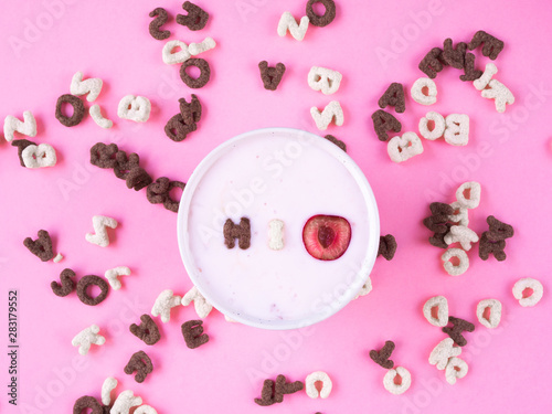 cereal breakfast bowl with yogurt and cherry on pink background top view