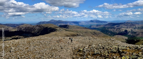 Hikers following the track off the summit photo