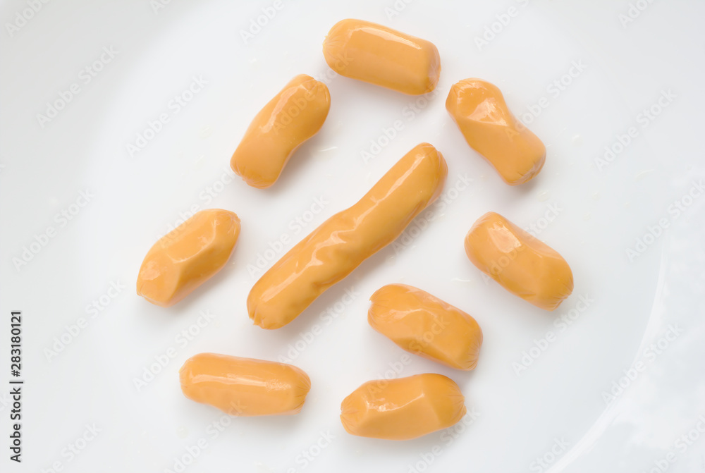 Many pork sausages, short and long pieces on a white background Many pork sausages, short and long pieces on a white background