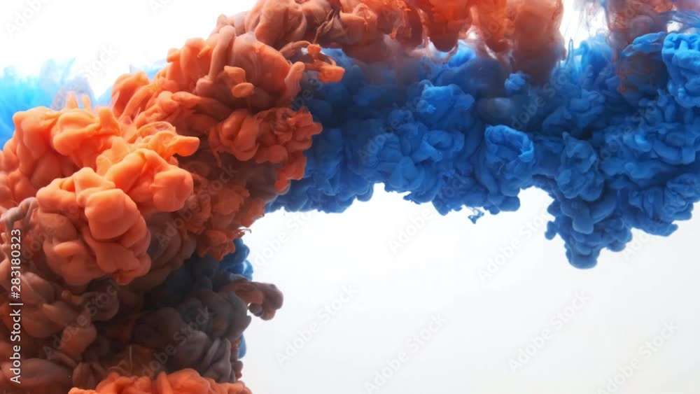 Slow motion shot of blue and orange ink water, shot with 4K camera.