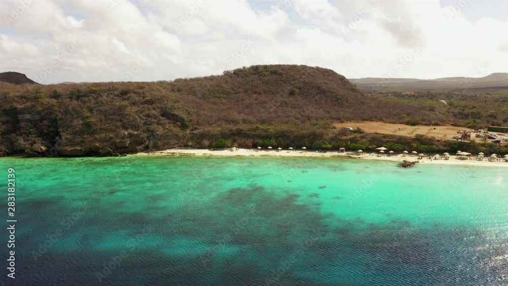 Aerial view of coast of Curaçao in the Caribbean Sea with turquoise water, cliff, beach and beautiful coral reef around Playa Porto Mari