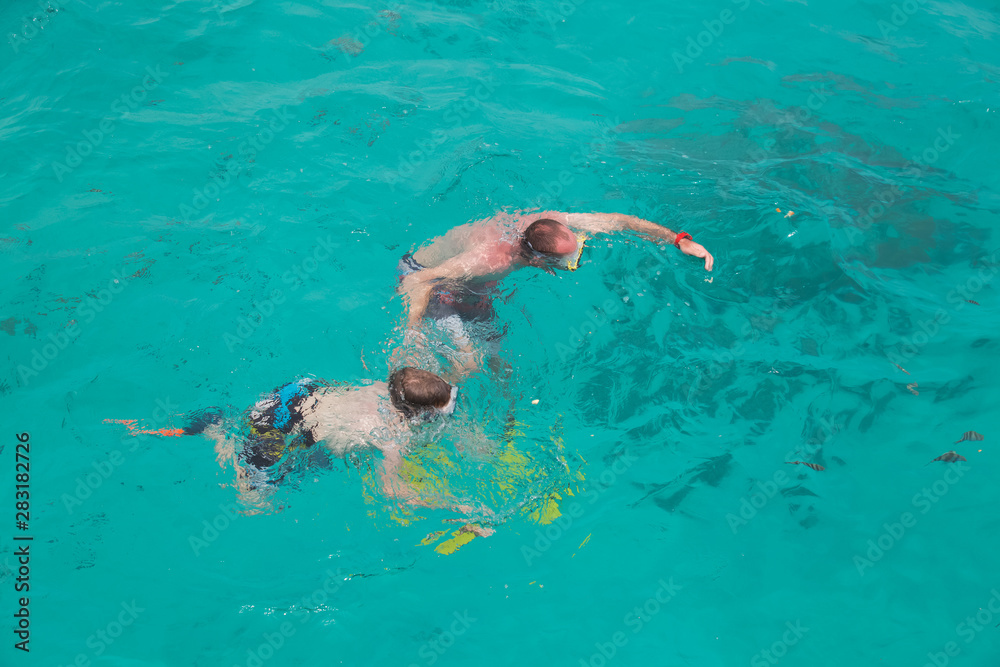 Father and son snorkeling. Family activity