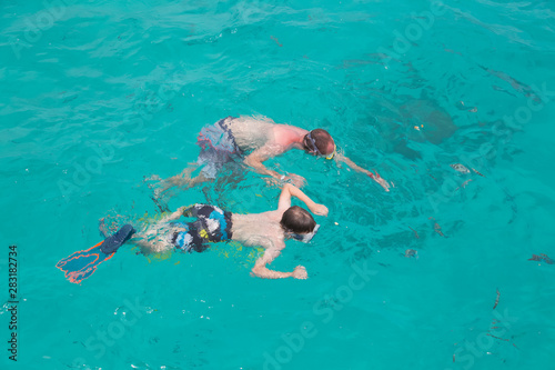 Father and son snorkeling. Family activity