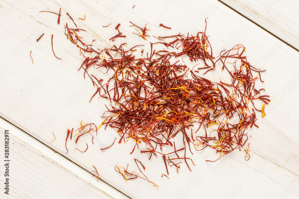 Fototapeta premium Lot of whole dry shaffron thread flatlay on white wood