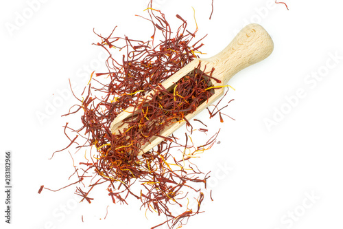 Lot of whole dry shaffron thread with wooden scoop flatlay isolated on white background photo