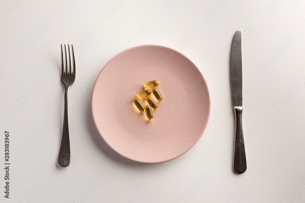 Omega 3 capsules on a plate. Flat lay. Omega 3 capsules on a plate. Flat lay.