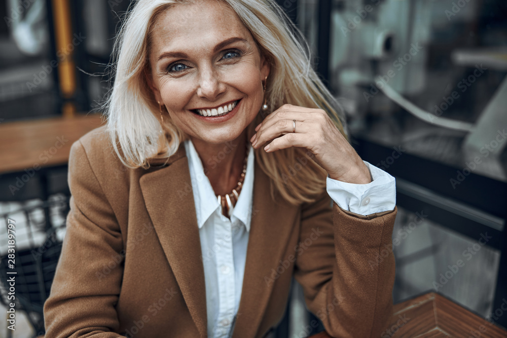 Mature woman outdoors expressing happiness stock photo - obrazy, fototapety, plakaty 