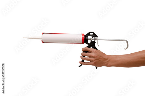 Men's hand holding Caulking gun and white silicone sealant