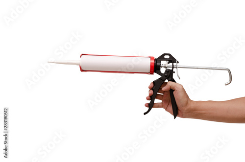 Men's hand holding Caulking gun and white silicone sealant