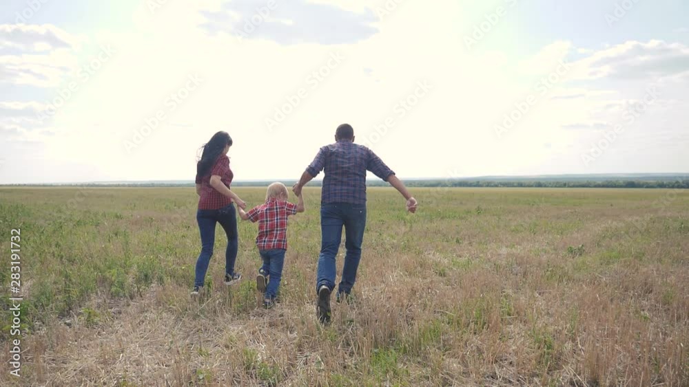 happy family run teamwork concept slow motion video. father mom and son running in nature sunset sunlight hold hand. happy family parents man and girl hold little boy running fast happy hand outdoors happy family run teamwork concept slow motion video. father mom and son running in nature sunset sunlight hold hand. happy family parents man and girl hold little boy running fast happy hand outdoors