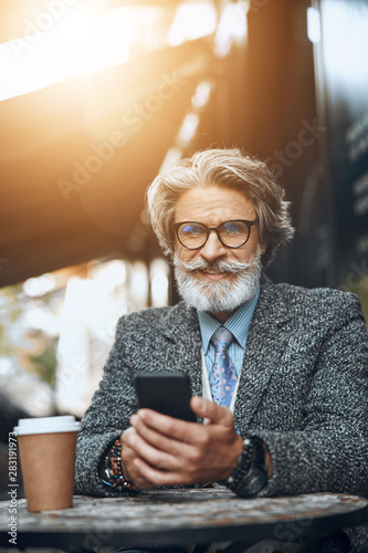 Man with smartphone enjoying sunny day stock photo