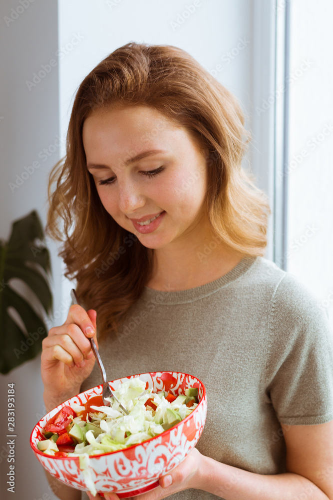Beautiful fit woman eating healthy salad. Vegetarian food, healthy lifestyle concept. Beautiful fit woman eating healthy salad. Vegetarian food, healthy lifestyle concept.
