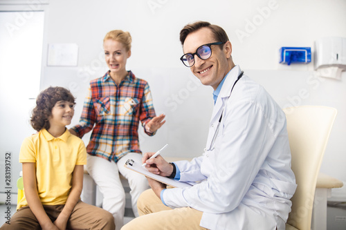 Happy doctor enjoying work with family stock photo