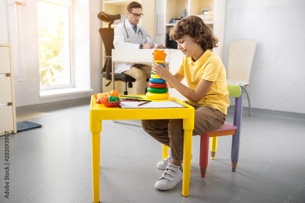 Cheerful boy playing with toys in hospital stock photo Cheerful boy playing with toys in hospital stock photo