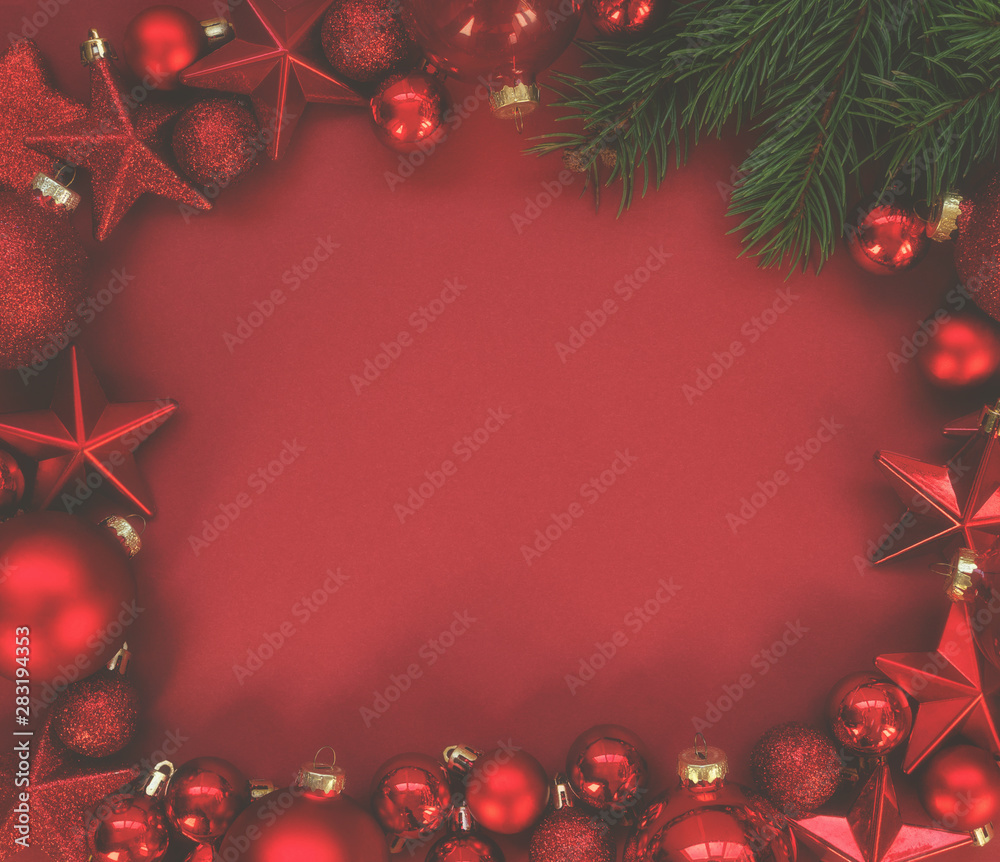 Christmas frame with a red ornament on a red background. Christmas, winter, new year concept. Top view with copy space for text. Christmas frame with a red ornament on a red background. Christmas, winter, new year concept. Top view with copy space for text.