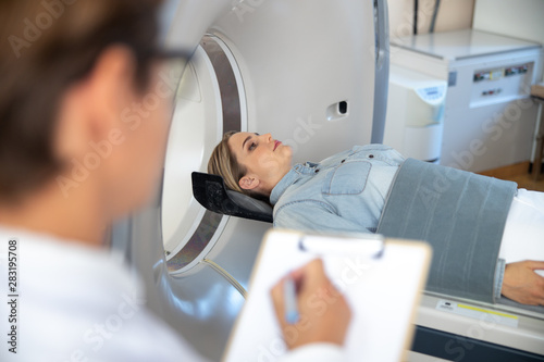 Lady lying on table of CT scan machine