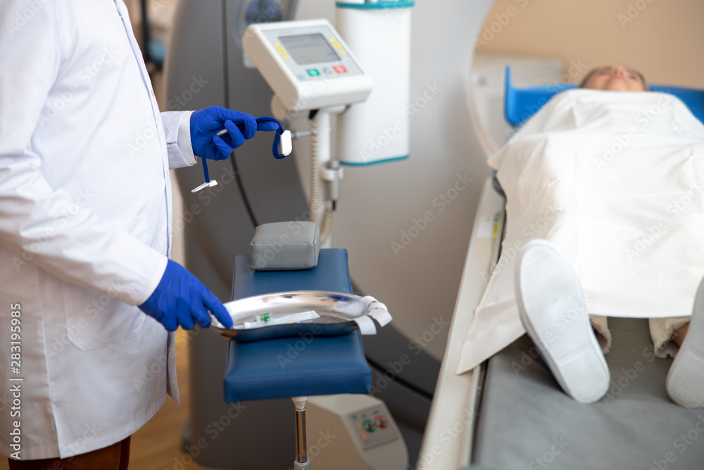 Doctor preparing venflon catheter during CT scan test Doctor preparing venflon catheter during CT scan test