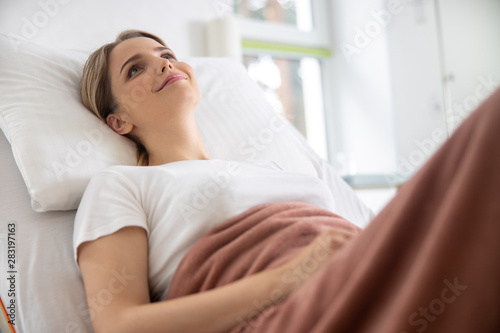Charming young woman resting in hospital room