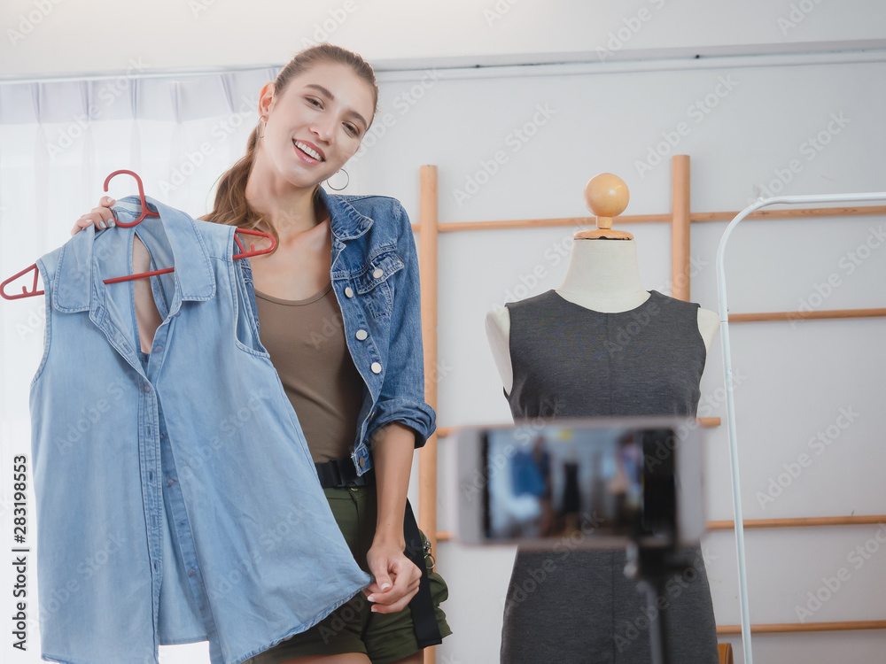 woman doing business in her home ,.Women are offering her clothes for sale online