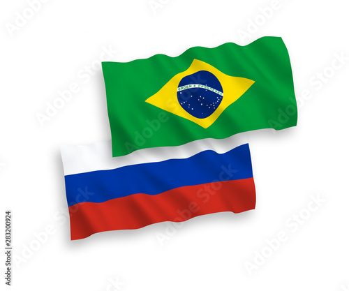 National vector fabric wave flags of Brazil and Russia isolated on white background. 1 to 2 proportion.