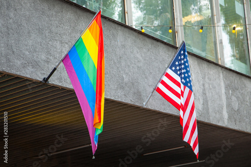 Flags of America and the LGBT community on the building. Sexual minorities in USA.