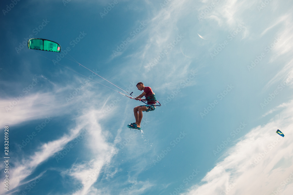 Professional kiter makes the difficult trick on a beautiful background. Kitesurfing Kiteboarding action photos man among waves quickly goes Professional kiter makes the difficult trick on a beautiful background. Kitesurfing Kiteboarding action photos man among waves quickly goes