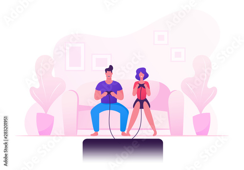 Family Couple Sitting on Sofa Playing Computer Games in Gaming Console