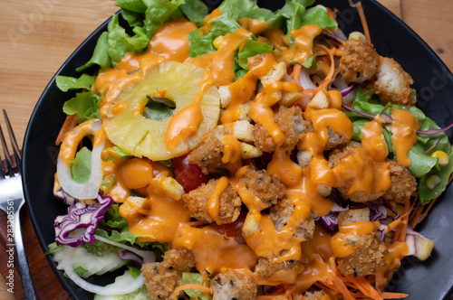 Salad and cheese dressing on table