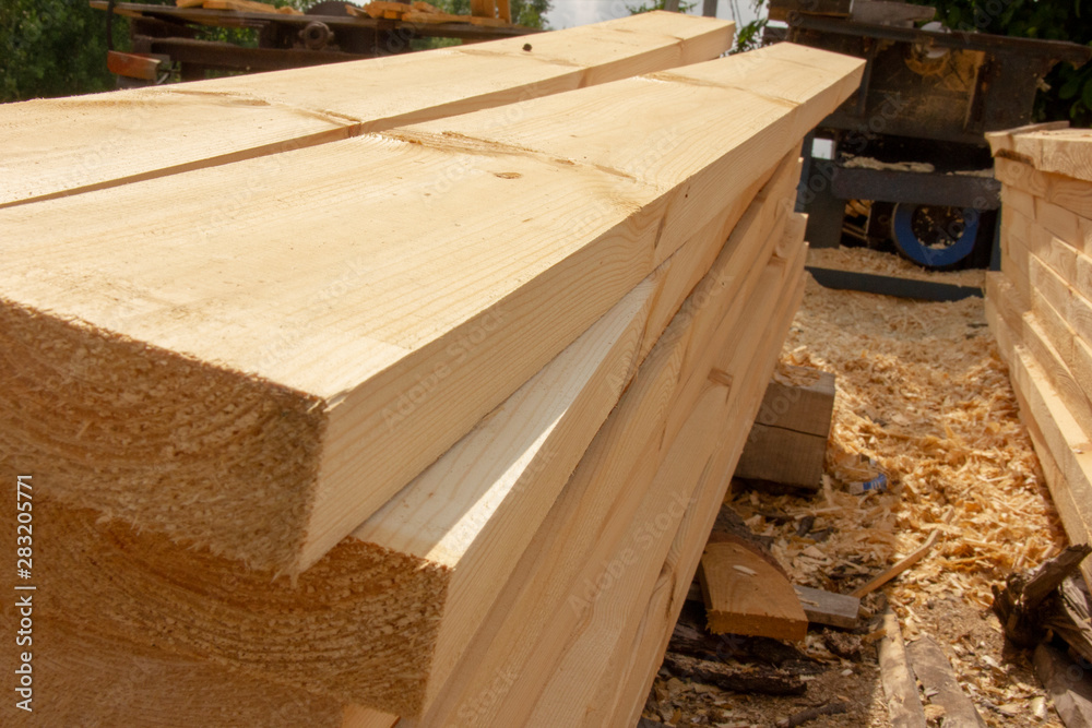 processed boards at a sawmill. Smooth, turned, polished boards at a wood processing plant. processed boards at a sawmill. Smooth, turned, polished boards at a wood processing plant.