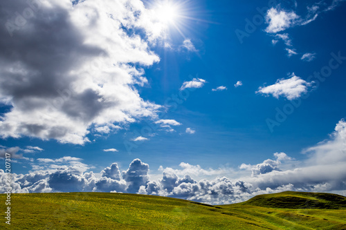 Bright Sun And Spectacular Cloud Formation Over The Green Cliffs At Clachtoll Beach Near Lochinver In Scotland photo