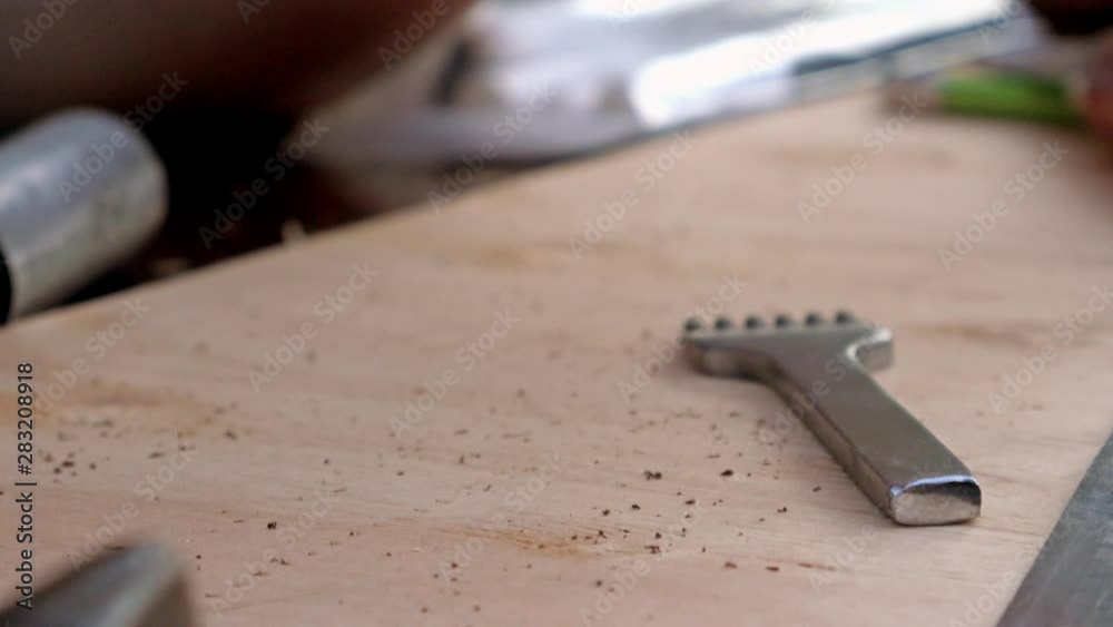 One man teach another man to sew leather wallet. Masterclass process. Two man making leather goods 