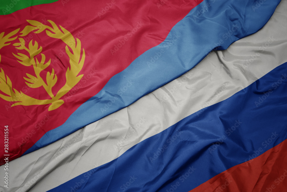 waving colorful flag of russia and national flag of eritrea.