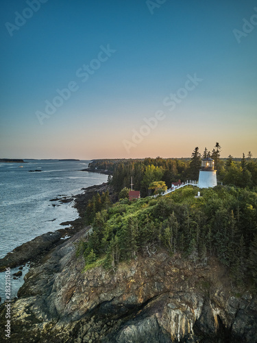 Aerial Drone image of the Owls Head Lighthouse perched on the cliffs at the entrance to Owls Head Harbor on the Maine Coast