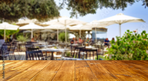 Table background with blurred outside restaurant. Empty space for advertising products and decortation.