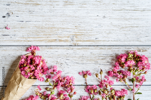 Fototapeta Naklejka Na Ścianę i Meble -  Spring Rustic background with pink flowers. Copy space on white wood. Valentine day internet sales concept, online shopping holiday background. Mockup, top view, flat lay