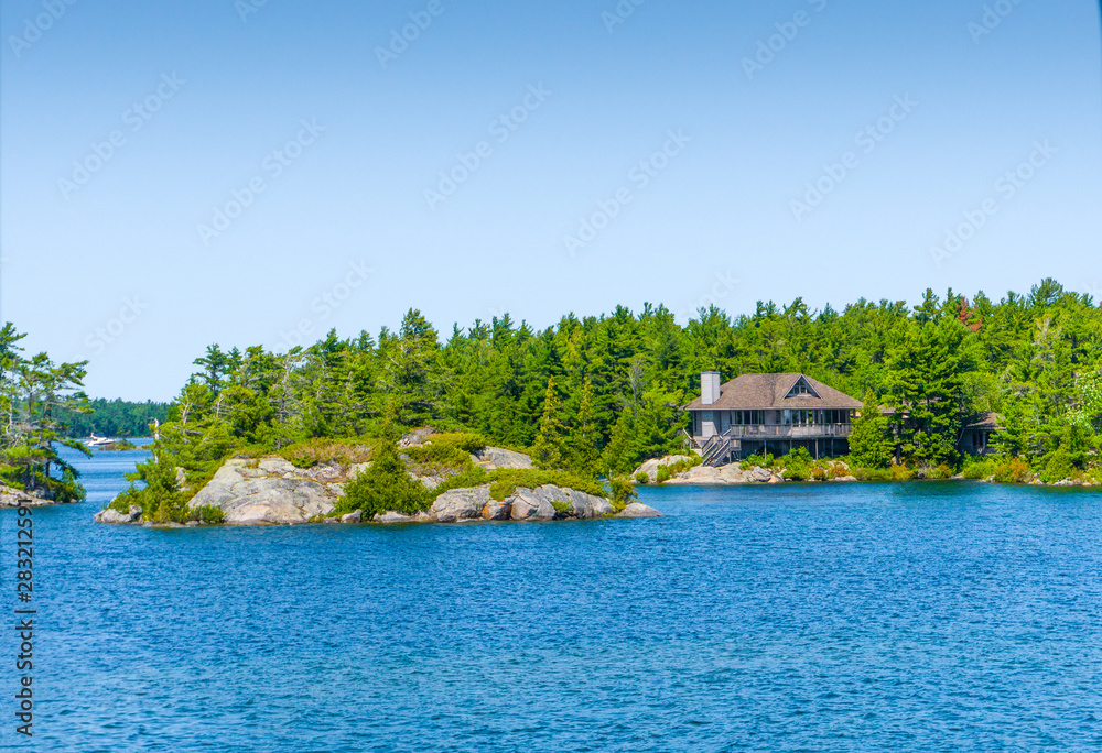Cottage on an island in a blue lake