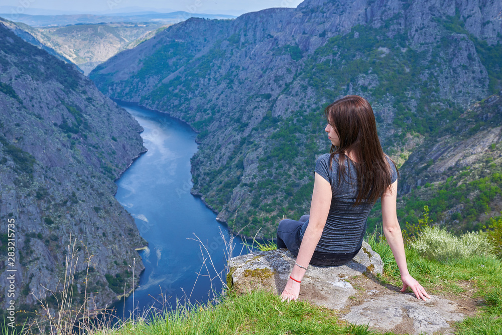 Naklejka premium Young woman contemplating the Sil Canyons in Ourense, Spain